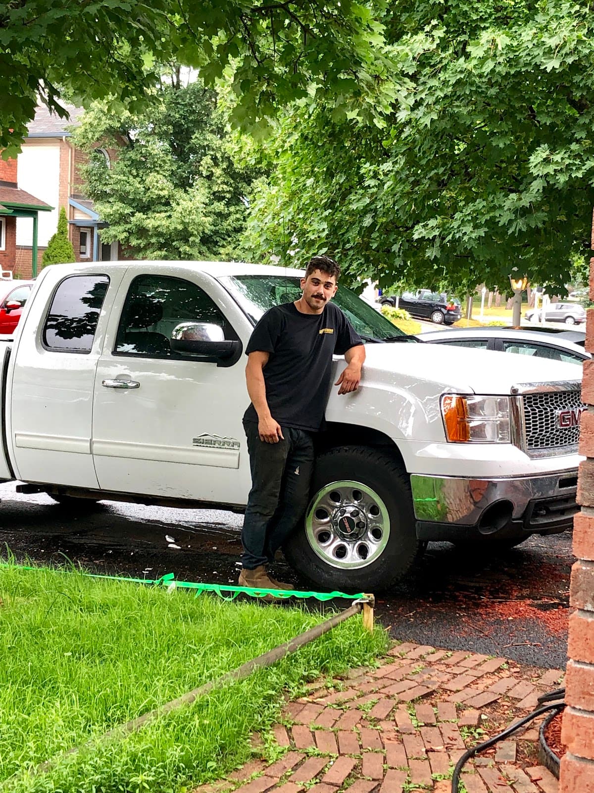 Christian standing beside his white GMC Sierra pickup truck