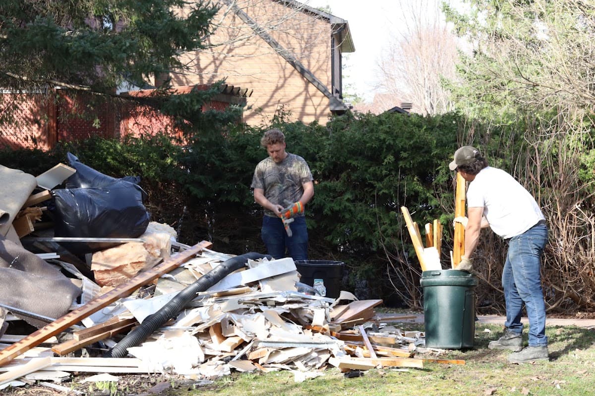 Christian's crew clearing a large pile of renovation debris from a backyard in the Ottawa–Gatineau area